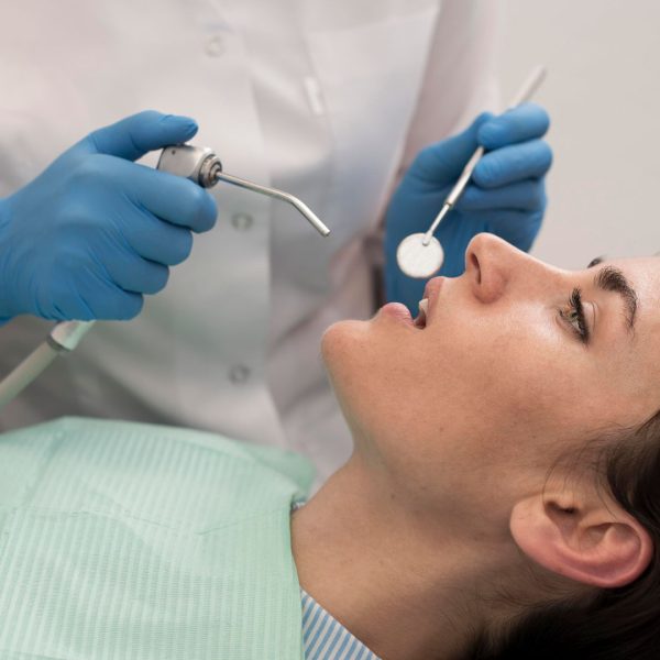 young-female-patient-having-dental-procedure-orthodontist